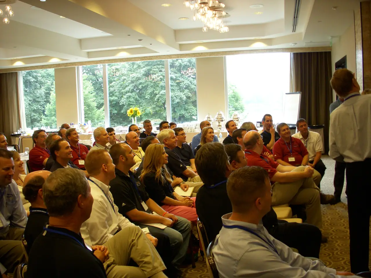 Smiling attendees seated together in an audience at an industry training event